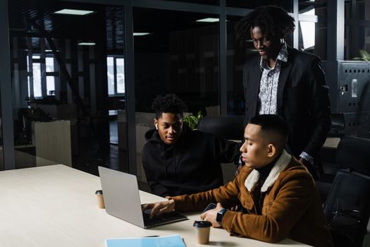 Multinational brainstorm group of colleagues working online on project in briefing room. Black african business man and asian work in team together