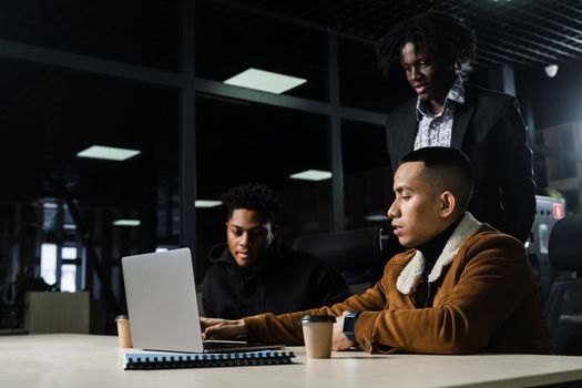 Teamwork online with laptop. Black african and asian colleagues. 3 multiethnic business men watch video conference with colleagues and employer