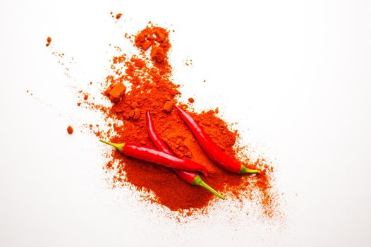 fresh red hot pepper and powder on a white background. High quality photo