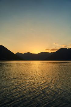 View of the sunset in Boko-Kotor Bay in Montenegro. Silhouettes of mountains. High quality photo