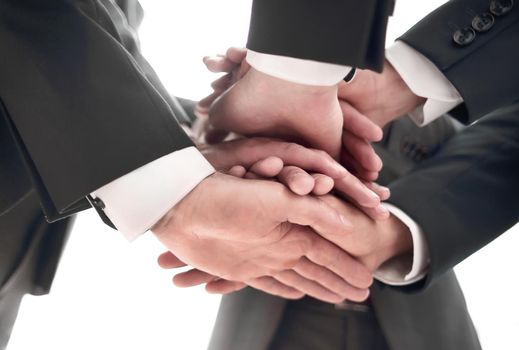 Close-up of businesspeople stacking hands in meeting. concept of unity