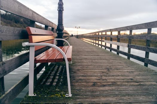 Bench on the boardwalk in the village of Yantarniy. High-quality photo