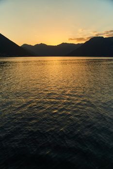 View of the sunset in Boko-Kotor Bay in Montenegro. Silhouettes of mountains. High quality photo