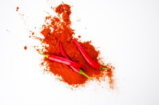 fresh red hot pepper and powder on a white background. High quality photo