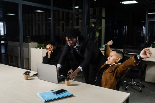 Teamwork online with laptop. Black african and asian colleagues. 3 multiethnic business men watch video conference with colleagues and employer