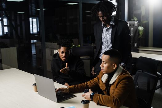 Teamwork online with laptop. Black african and asian colleagues. 3 multiethnic business men watch video conference with colleagues and employer