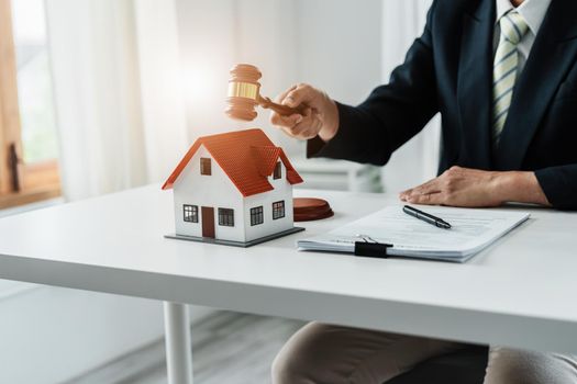 Focus at gavel, Attorney or Lawyer holding a pen is consulting with a client to explain the pattern of answering questions before going to court to decide a lawsuit