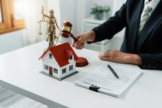 Focus at gavel, Attorney or Lawyer holding a pen is consulting with a client to explain the pattern of answering questions before going to court to decide a lawsuit