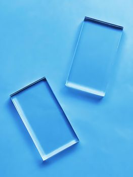 Glass device on blue background, future technology and abstract screen mockup design concept