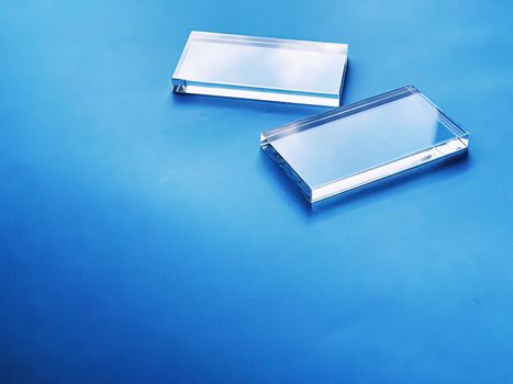 Glass device on blue background, future technology and abstract screen mockup design concept