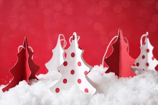 christmas tree made from paper in white and red, on a snow, decoration
