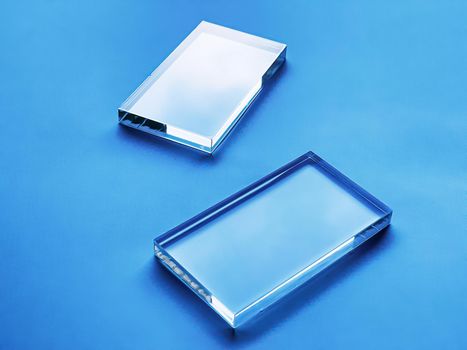 Glass device on blue background, future technology and abstract screen mockup design concept