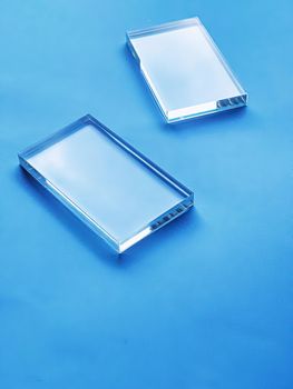 Glass device on blue background, future technology and abstract screen mockup design concept