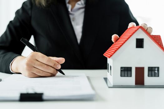 Law, agreement, contract, mortgage, woman holding a pen, reading the contract document in buying a house to see the interest rate and asking for the limit to assess the risk before buying a house.