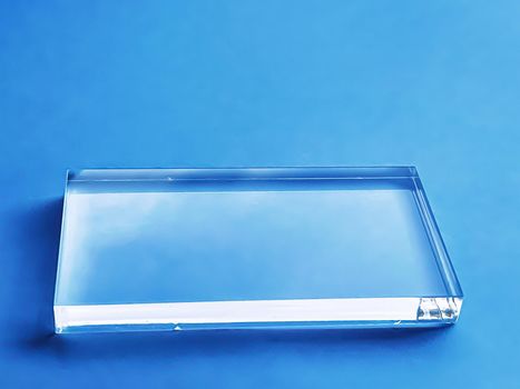 Glass device on blue background, future technology and abstract screen mockup design concept