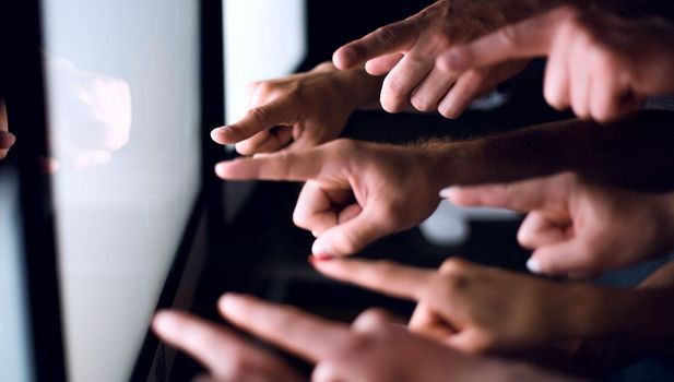 business team pointing their fingers at the computer screen .photo with copy space