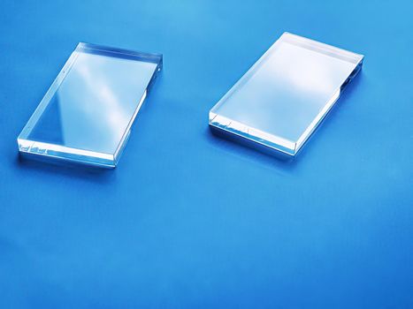 Glass device on blue background, future technology and abstract screen mockup design concept