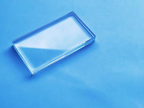 Glass device on blue background, future technology and abstract screen mockup design concept