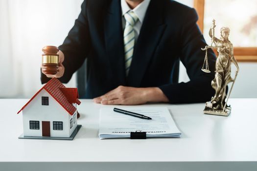 Focus at gavel, Attorney or Lawyer holding a pen is consulting with a client to explain the pattern of answering questions before going to court to decide a lawsuit