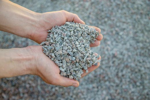 Man holding small rubble in his hands