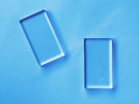 Glass device on blue background, future technology and abstract screen mockup design concept