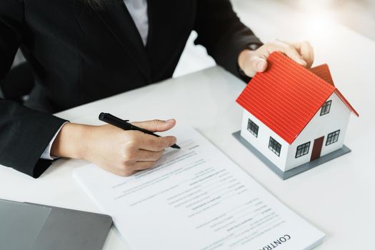 Law, agreement, contract, mortgage, woman holding a pen, reading the contract document in buying a house to see the interest rate and asking for the limit to assess the risk before buying a house.