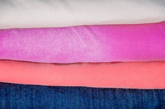 close up stecks of multicolored light clothes background.