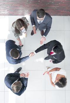 top view.business partners shaking hands.business concept