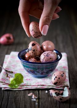 Quail eggs on a wooden background vertical