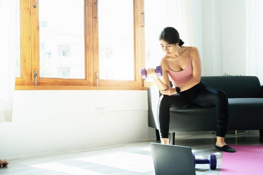 stress relief, , breathing exercises, meditation, portrait of Asian healthy woman lifting weights to strengthen her muscles after work