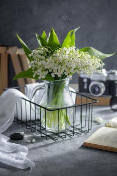Lilies of the valley in a glass vase on a table