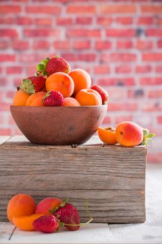 Apricots in a clay bowl Vertical