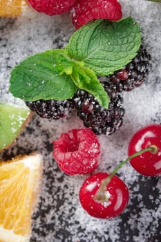 Fresh Berries with snow and mint macro