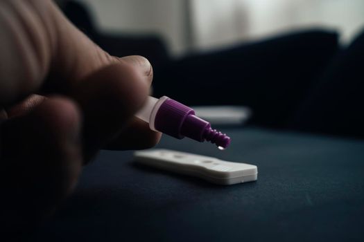 Man using a rapid antigen test kit. Rapid antigen testing is a screening tool to help to detect Corona COVID-19 in people without any symptoms of Sars-CoV-2