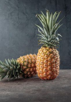 Ripe pineapple on the dark table