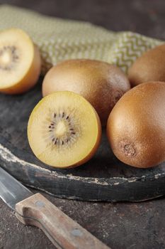 Kiwi on a black wooden board on a dark background