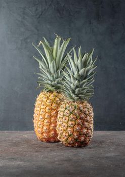 Ripe pineapple on the dark table