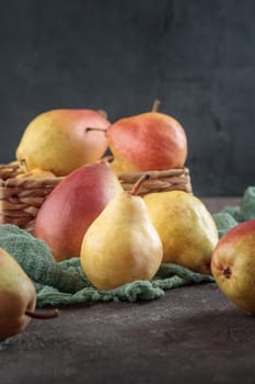 Various ripe pears on a dark background