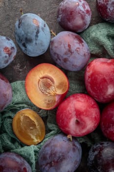 Fresh ripe plums on a dark background