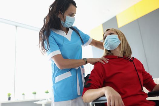 Portrait of medical worker visit patient in room, woman in wheelchair in rehabilitation center. Disabled people, medicine, recovery, healthcare concept