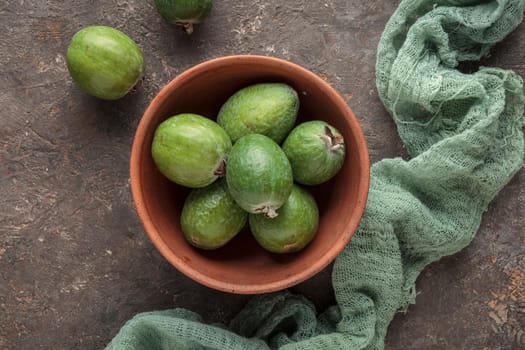 Feijoa in a bowl on dark table