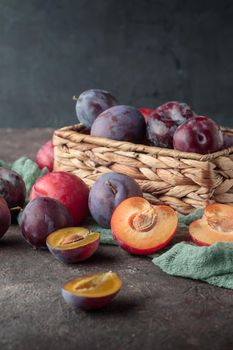 Fresh ripe plums on a dark background