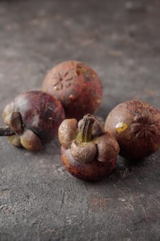 Mangostins on a dark table background