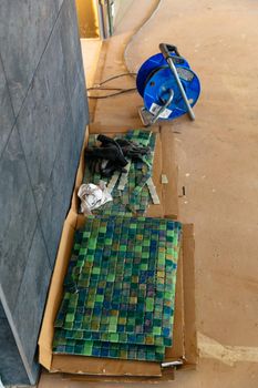 Ceramic tiles, green mosaic. Renovation in progress concept.