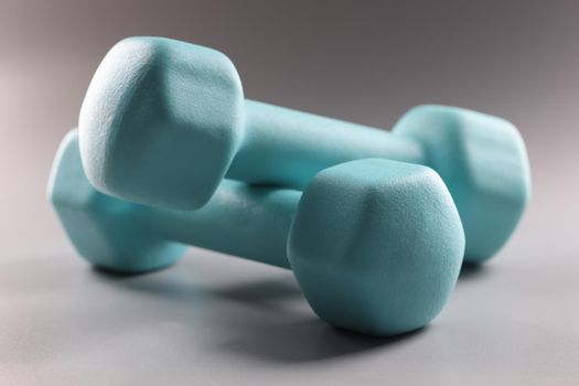 Close-up of heavy blue dumbbells for workout, plan weight loss, sport activity, get physical. Sport, health, physical activity, habit, body change concept