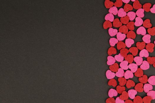 Hearts abstract background in red pink colors, on black texture - Happy Valentine's Day - Hearts Love pattern.