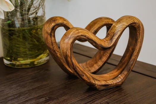 Two handmade wooden carved hearts on a table. Valentine day concept