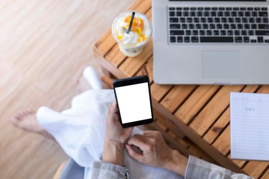 Close up hands of woman using mobile phone, cell phone in coffee shop. Hands of women holding blank empty screen smart phone in cafe. Women relax with mobile phone sit in restaurant