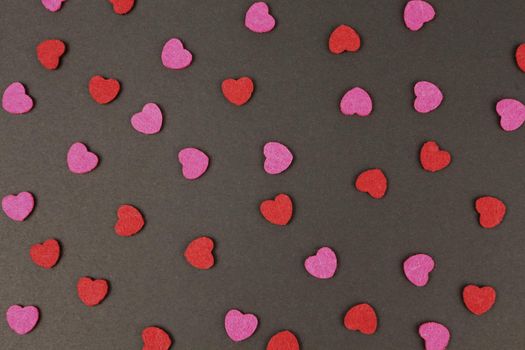 Hearts abstract background in red pink colors, on black texture - Happy Valentine's Day - Hearts Love pattern.