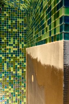 Process of building a sauna, mosaic tile bathrooms. Renovation. Laser level. Construction tools. Modern green mosaic wall.